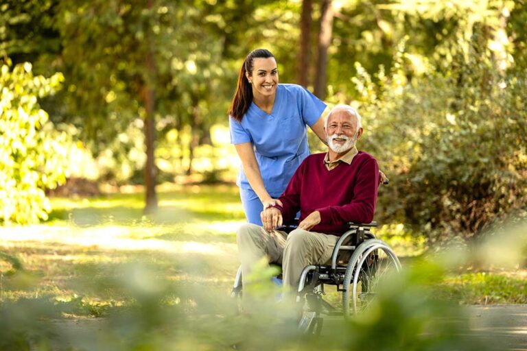 Older adult reviewing assisted living costs with a family member at a dining table with paperwork.